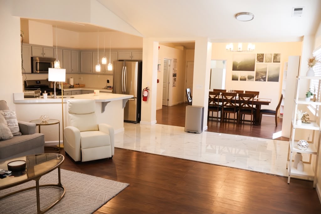 The shared living room, kitchen and dining area at Cozy Care Homes